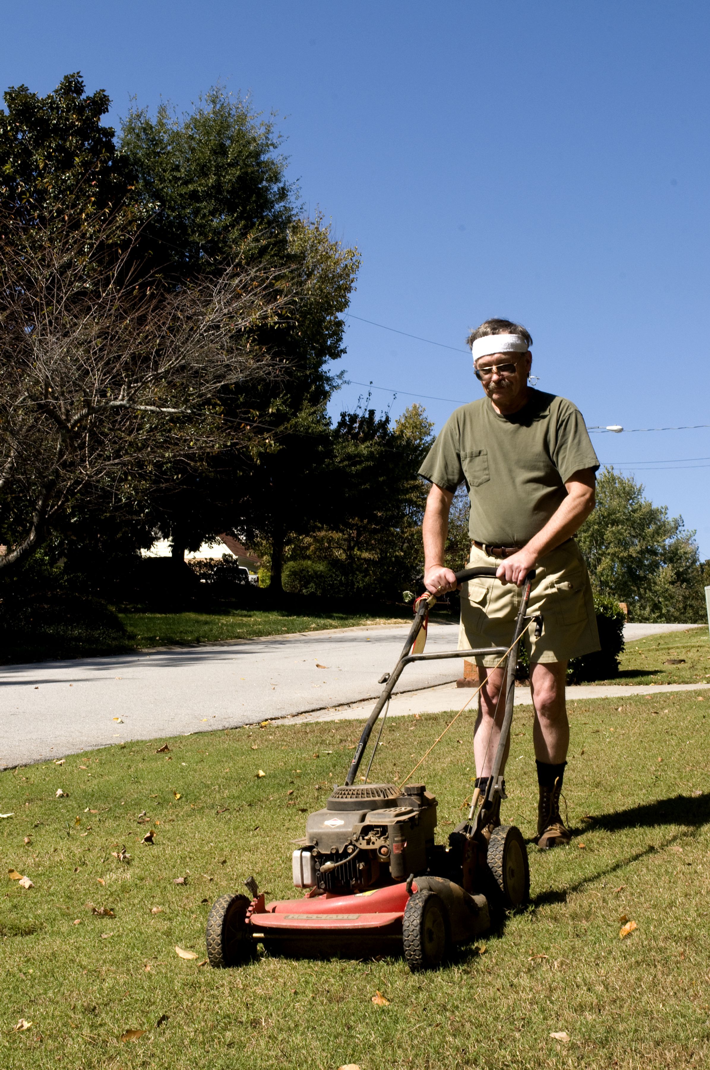Man was pictured mowing his front lawn with a push lawnmower